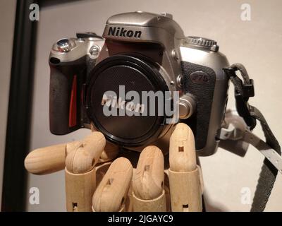 Nikon F75 on Ikea handskalad wooden hand. Stock Photo