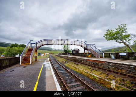 The rusty pedestrian footbridge over the tracks at the railway station in Achnasheen, a small village in Ross-shire, Highland council area,  Scotland Stock Photo