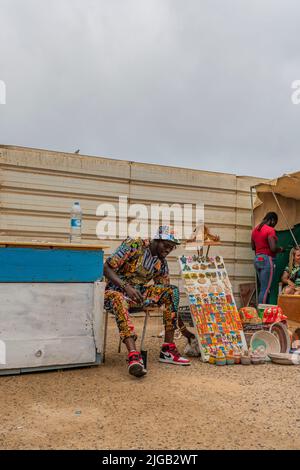 SANTA MARIA, CAPE VERDE, - JUNE 20.2022: Street view with a man selling souvenirs in Santa Maria, Sal Island, Cape Verde Stock Photo