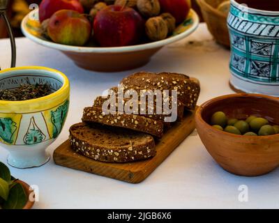 sliced whole grain cereal bread on a cutting board Stock Photo