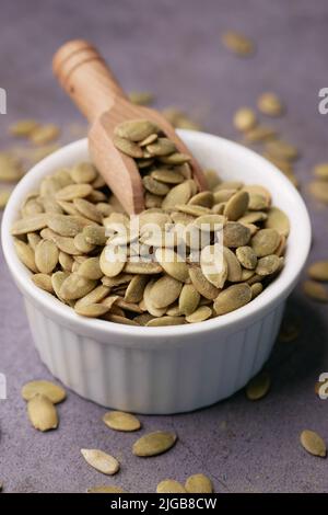 pumpkin seeds in a small bowl on black background  Stock Photo