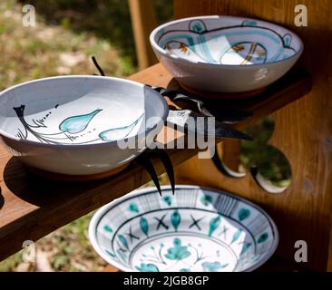 eramic plates decorated with blue flowers placed on a shelf Stock Photo