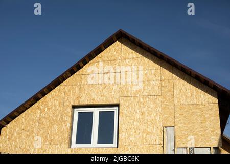 Roof of house. Roof on country house. Windows in wall. Country dwelling. Stock Photo