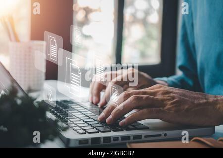 Businessman hand using laptop computer with document management icon, Document management data system business internet technology concept. Stock Photo