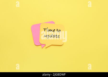 Sticky notes on yellow background. Time to update Stock Photo