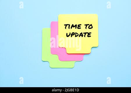 Sticky notes on blue background. Time to update Stock Photo