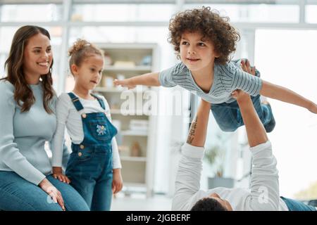 Ill always be here to lift you up. a young family playing together at home. Stock Photo