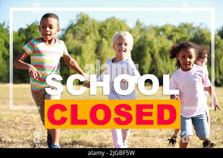 Text SCHOOL CLOSED and group of running children in park Stock Photo