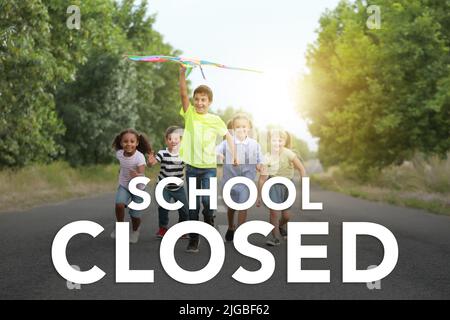 Text SCHOOL CLOSED and little children flying kite outdoors Stock Photo