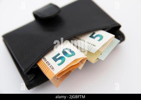 Closeup of euro banknotes sticking out of a wallet Stock Photo