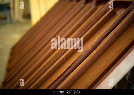Brown boxes made of wood. Boards in carpentry workshop. Manufacture of furniture. Brown board. Stock Photo