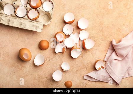 Composition with broken egg shells on color background Stock Photo