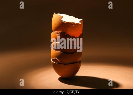 Stack of broken egg shells on dark color background Stock Photo