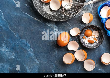 Composition with broken egg shells on color background Stock Photo