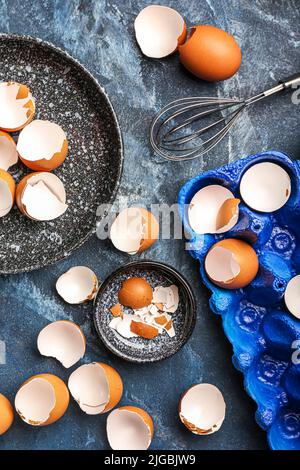 Composition with broken egg shells on color background Stock Photo