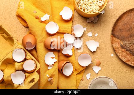Composition with broken egg shells on color background Stock Photo