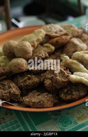 ndonesian fried snacks or known as gorengan include tempeh, tofu or tahu bulat, pisang goreng, and lentho Ponorogo local snack made from tolo beans. Stock Photo