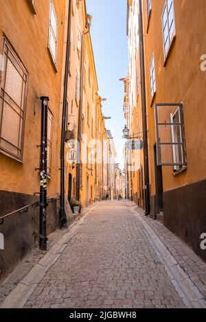 Empty alley amidst residential buildings in old town at capital city against sky Stock Photo