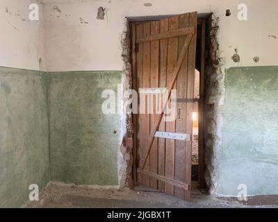 Half open door in abandoned house Stock Photo