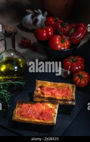 Traditional Spanish appetiser - 'Pan Tomaca' (bread with tomato) toasted bread with garlic topped with freshly squeezed tomato and virgin olive oil. Stock Photo