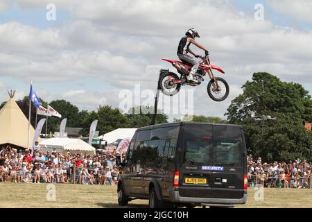 Lawford, UK. 09th Jul 2022. The Tendring Hundred Show is the premier agricultural show in Essex. Mark Stannage and his  team of daredevils perform stunts with cars, motorbikes and high fall stunts. Credit: Eastern Views/Alamy Live News Stock Photo