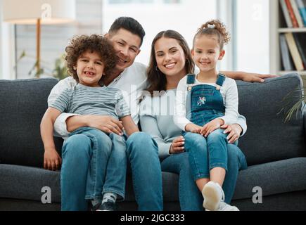 Seeing them grow before our eyes. a young couple spending time with their children. Stock Photo
