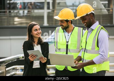 Architect, civil engineer and worker looking at plans and blueprints, discussing issues at the construction site. Stock Photo