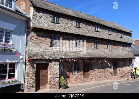 The old Nunnery in Dunster, Somerset dates back to the 15th century and is a terrace of three houses, three storeys tall, built of stone with a slate Stock Photo