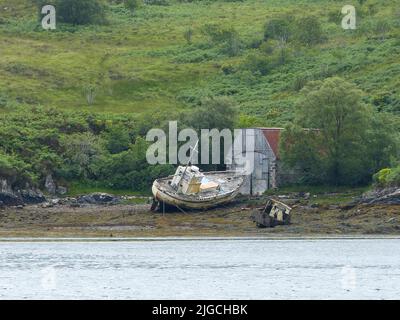 two old shipwrecks at low tide in Scotland Stock Photo