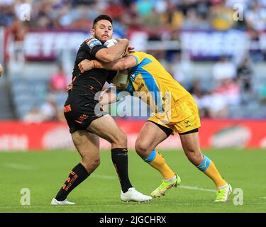 Newcastle, UK. 09th July, 2022. Niall Evalds #1 of Castleford Tigers is tackled by Aidan Sezer #7 of Leeds Rhinos in Newcastle, United Kingdom on 7/9/2022. (Photo by Mark Cosgrove/News Images/Sipa USA) Credit: Sipa USA/Alamy Live News Stock Photo