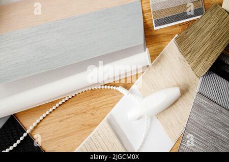 Samples of fabrics of different textures and colors in the form of a catalog for the selection of fabrics for fabric blinds. Samples of blinds day and Stock Photo