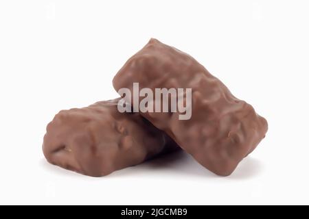 Chocolate bars with peanuts and caramel. Crispy bits of chocolate bars. Close up view. Stock Photo
