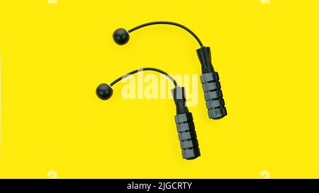 Cordless jump rope isolated on yellow background. Modern technologies in sports accessories for fitness at home and in the gym. Ropeless skipping rope Stock Photo