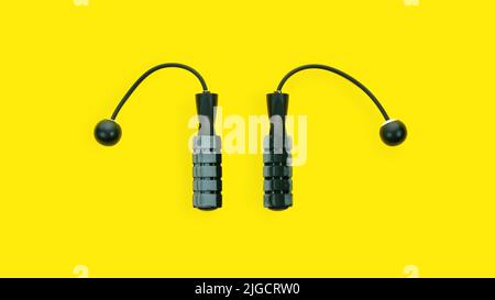 Ropeless skipping rope close up top view on yellow background. Cordless jump rope isolated. Modern technologies in sports accessories for fitness at h Stock Photo