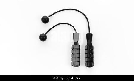 Cordless jump rope isolated on white background. Ropeless skipping rope close up with copy space. Modern sports accessories for fitness at home and in Stock Photo