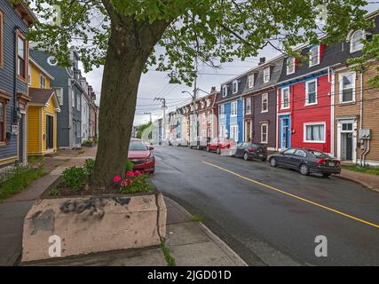 St. John’s, Newfoundland and Labrador, Canada – June 21, 2022:  A streetscape of colorful row houses, commonly called jelly bean houses Stock Photo