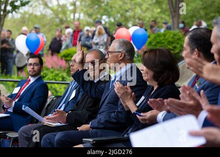 Attendees clap as Washington Governor Jay Inslee (center) is introduced, at a naturalization ceremony at Fisher Pavilion in Seattle on Monday, July 4, Stock Photo