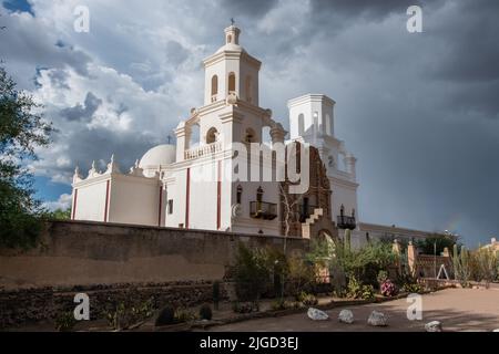 Beautiful vista of the San Xavier del Bac Mission in Tucson, Arizona, under dramatic monsoon sky Stock Photo