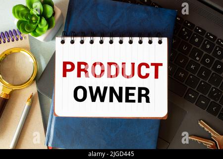 PRODUCT OWNER . Text written on the notepad with office tools and documents Stock Photo