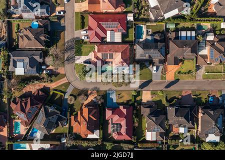 Top down aerial view early on a winter's morning above a neighbourhood street corner in outer suburban Sydney, Australia. Stock Photo