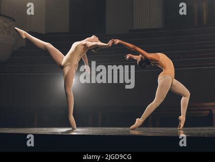 When you dance, you enjoy the luxury of being you. a group of ballet dancers practicing a routine on stage. Stock Photo