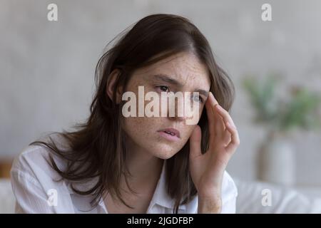 Close up face of sad frustrated freckled teenage girl Stock Photo