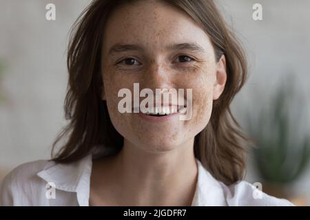 Close up portrait smiling young freckled woman Stock Photo