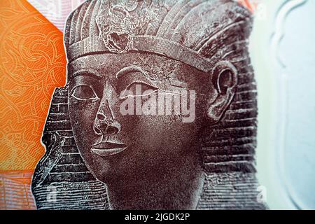 Queen Hatshepsut closeup view from the reverse side of the new first Egyptian 10 LE EGP ten pounds plastic polymer banknote with a part of the great p Stock Photo