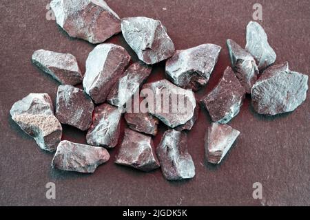 Granites are coarsely crystalline plutonic rocks rich in quartz and feldspar, but also contain dark minerals, Stock Photo