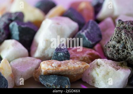 Granites are coarsely crystalline plutonic rocks rich in quartz and feldspar, but also contain dark minerals, Stock Photo