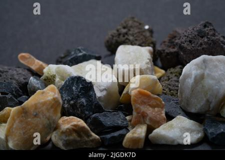 Granites are coarsely crystalline plutonic rocks rich in quartz and feldspar, but also contain dark minerals, Stock Photo