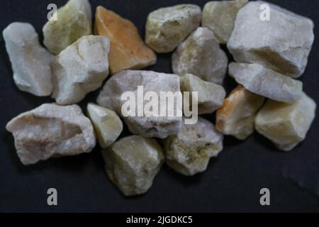 Granites are coarsely crystalline plutonic rocks rich in quartz and feldspar, but also contain dark minerals, Stock Photo