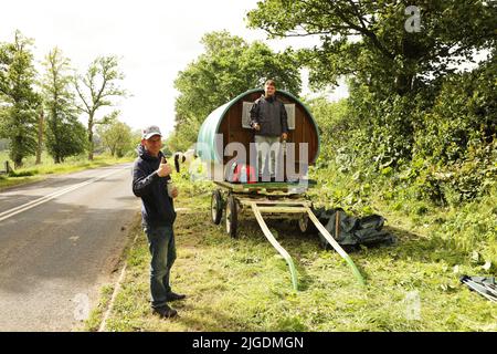 Two young men with gypsy caravans camping on the verge near Appleby Horse Fair, Appleby in Westmorland, Cumbria Stock Photo