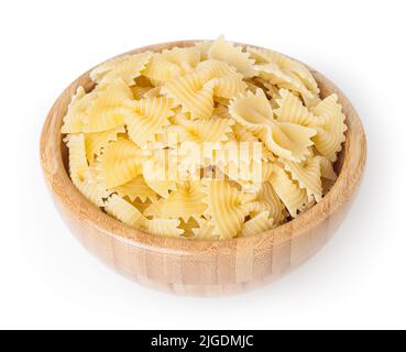 Bow tie pasta in wooden bowl isolated on white background with clipping path Stock Photo